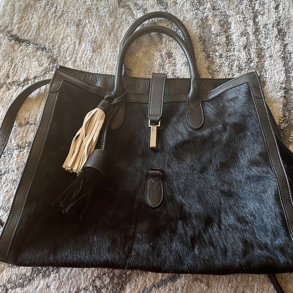 Great condition faux fur trim leather tote. Black with tassel accents. 18 x 13"